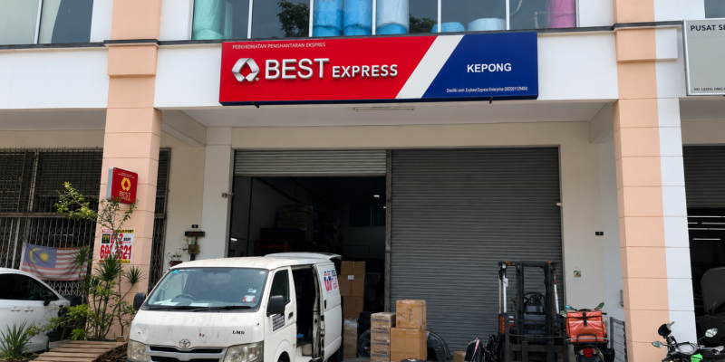 BEST Express Kepong station exterior with company signage, delivery van and packages at the loading bay