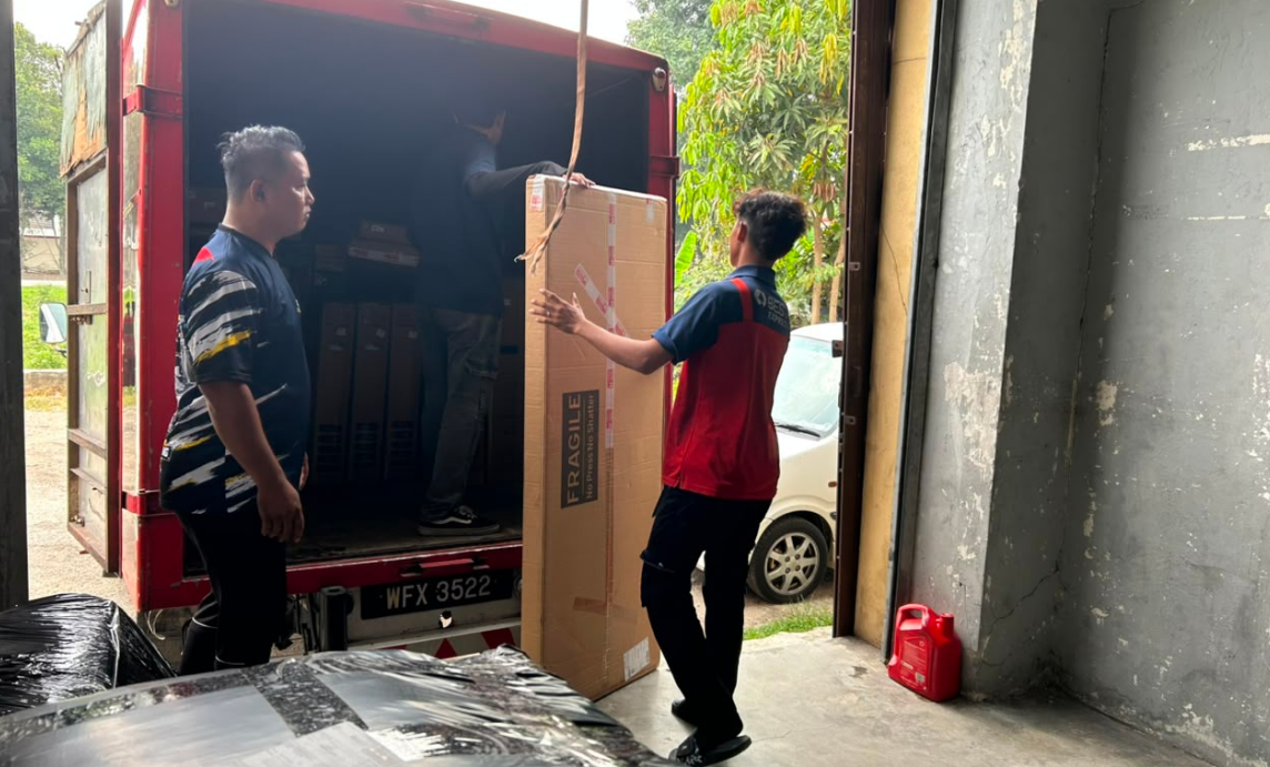 Saifu and team handling parcels at the BEST Express Malaysia Puncak Alam station during peak season